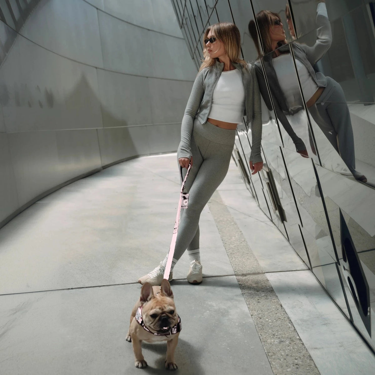 Woman walking a French bulldog on the Sakura bungee leash