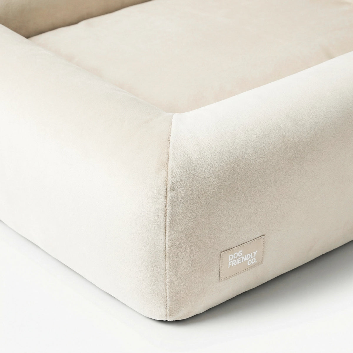 Close-up of the Beige orthopedic memory foam dog bed showing the soft cover, raised sides and reinforced stitching.