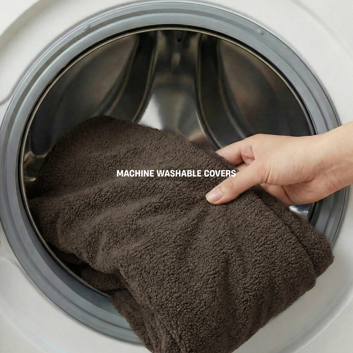 Brown Bouclé dog bed cover being removed for washing with MACHINE WASHABLE COVERS label.