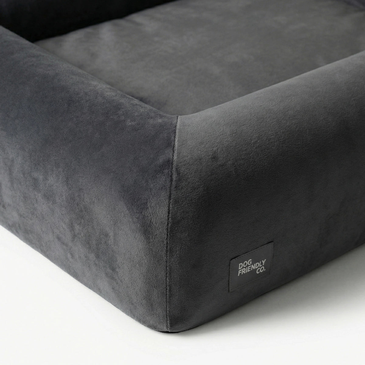 Close-up of the Charcoal orthopedic memory foam dog bed showing the soft outer cover, raised sides and reinforced stitching.
