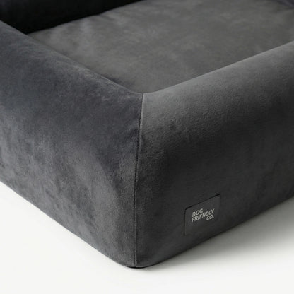 Close-up of the Charcoal orthopedic memory foam dog bed showing the soft outer cover, raised sides and reinforced stitching.