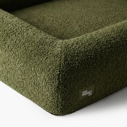 Close-up of the Green Bouclé dog bed showing the soft textured cover and raised supportive sides.