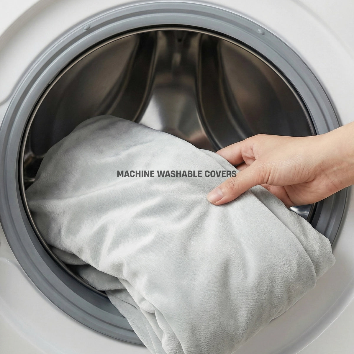 Grey dog bed cover being removed for machine washing.