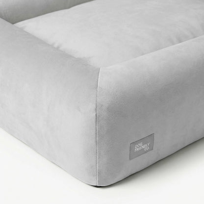 Grey orthopedic dog bed showing the breathable cover and supportive layered foam construction.